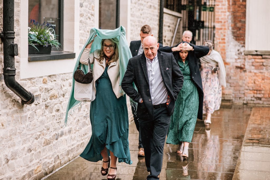 rain at blackfriars priory wedding day guests. Gloucestershire wedding photographer