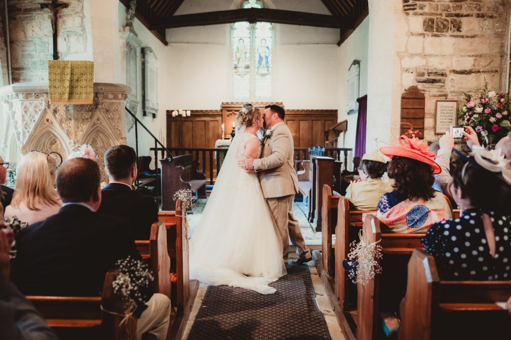 A Bride and Grooms first kiss at Boddington Church