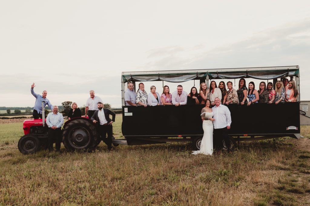 Group photos on a tractor / Trailer at Hardwick Moat Weddings