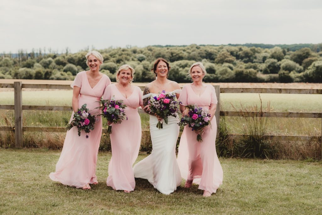 Bride and bridesmaids walking at Hardwicke Moat Weddings