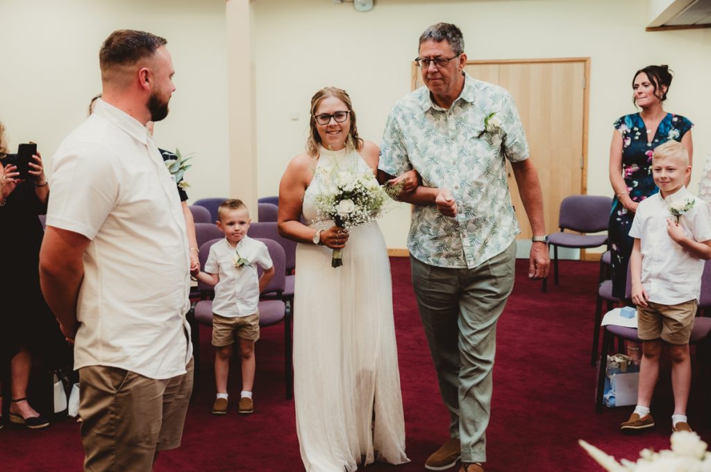 Bride and dad walking down the aisle at Evesham Registry office