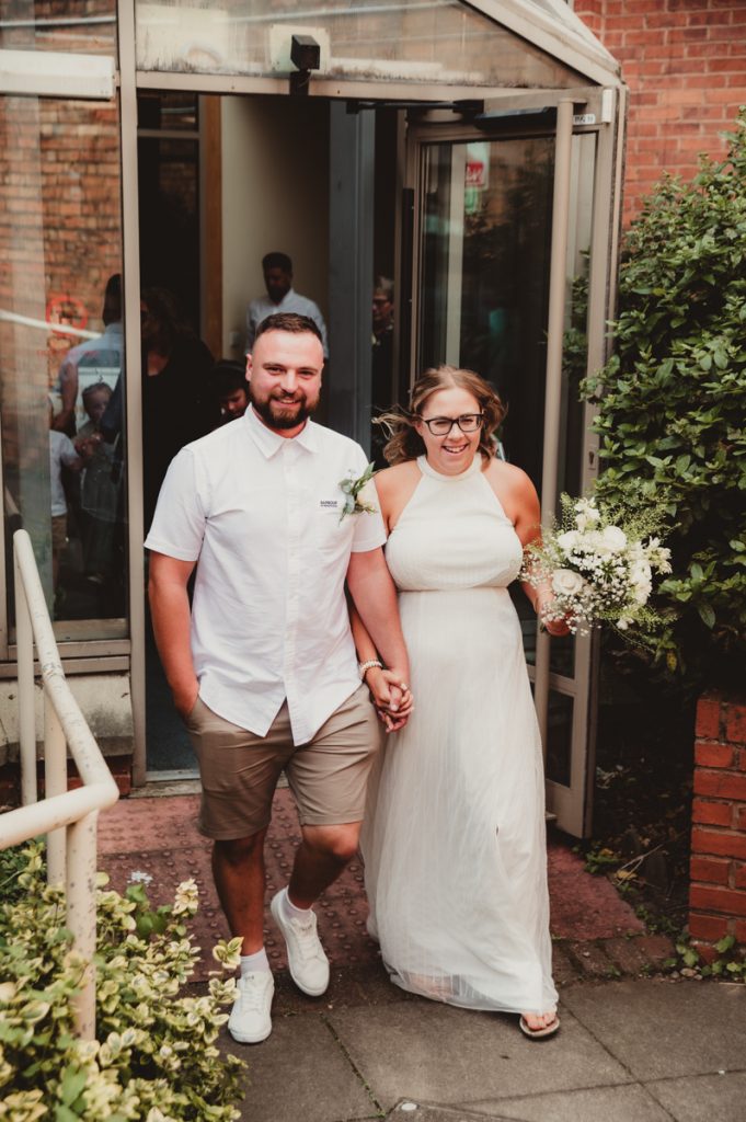 Bride and groom leaving Evesham Registry Office