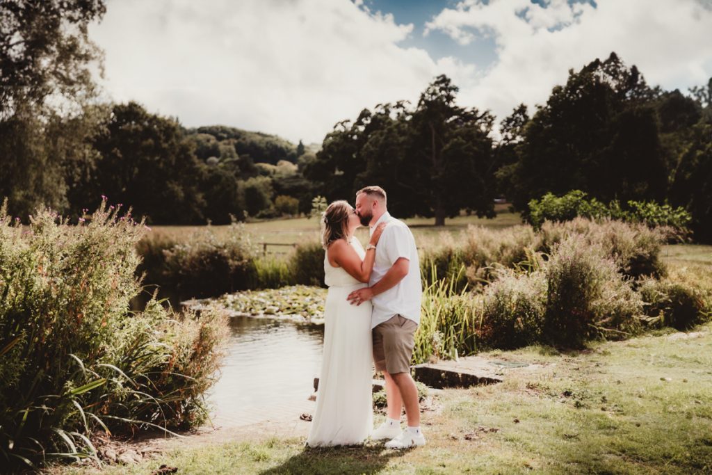 Bride and groom kissing at Dumbleton Cricket Club