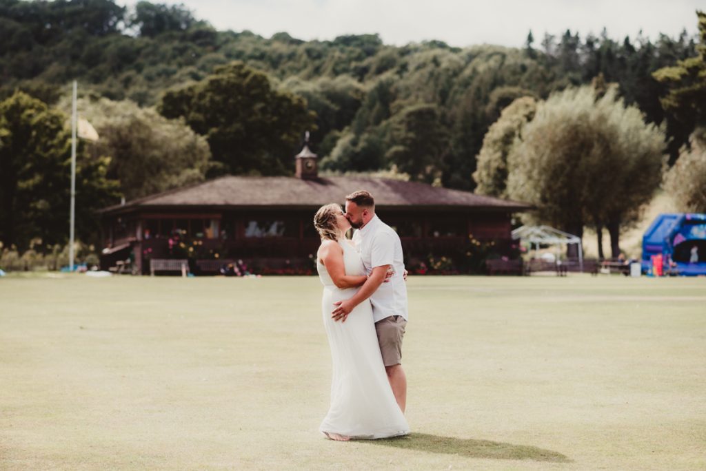 Bride and groom kissing at Dumbleton Cricket club 