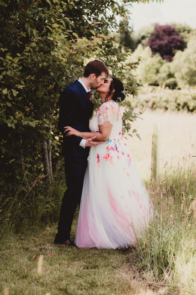 A bride and groom enjoying a kiss. Captured by a Gloucestershire Wedding Photographer