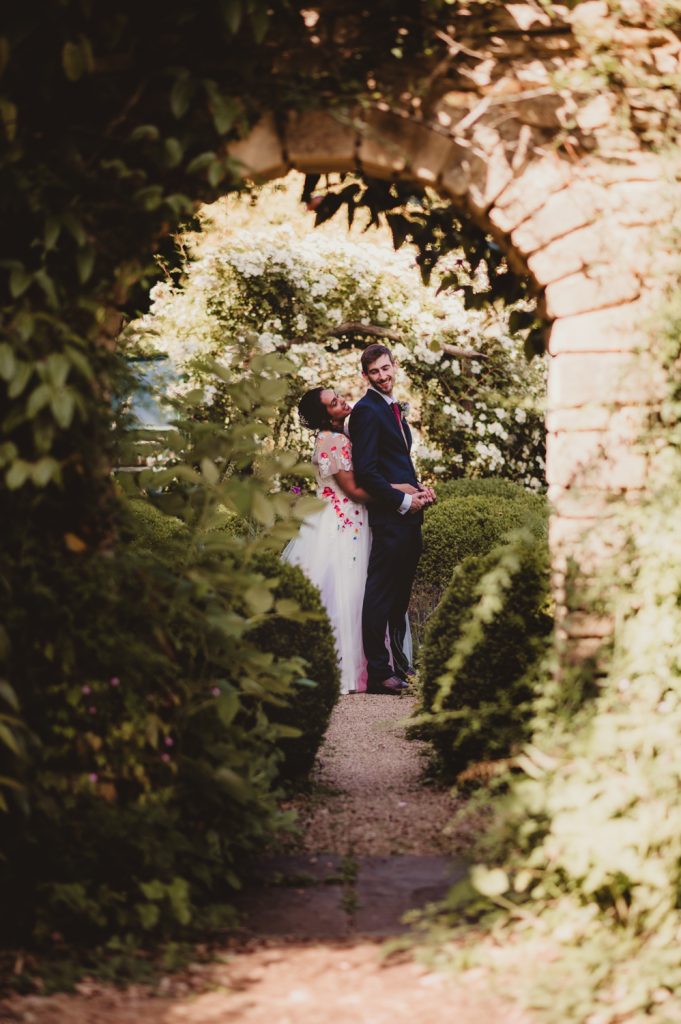 A bride and groom under the arch at the Matara Centre Captured by a Matara Centre Wedding photographer