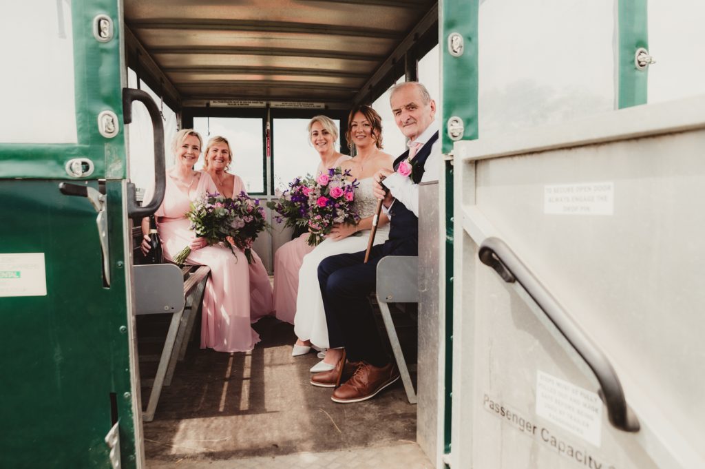 Bridal Perty in the tractor trailer at Hardwick Moat Weddings