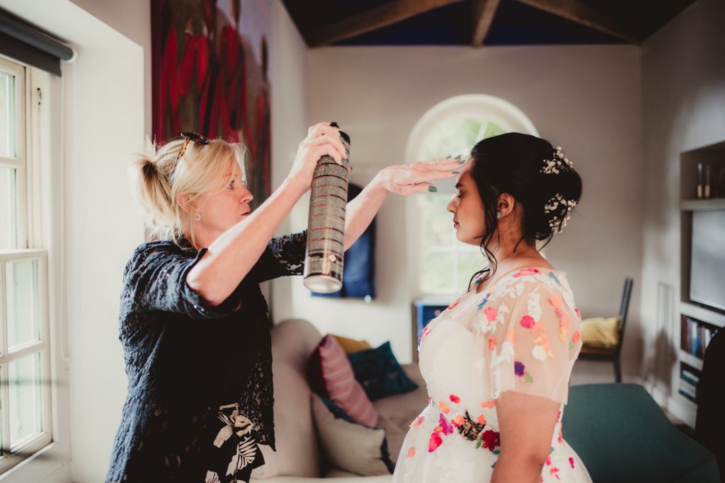 A bride having the finishing touches of her hair done at the Matara centre.