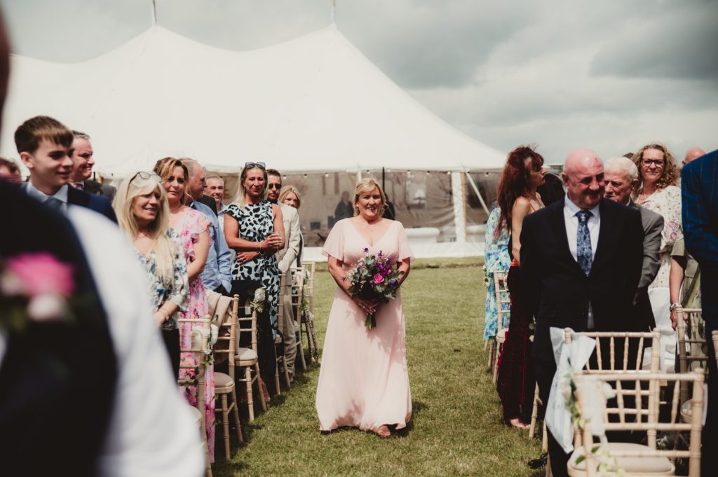 bridesmaid walking down aisle at Hardwick Moat weddings