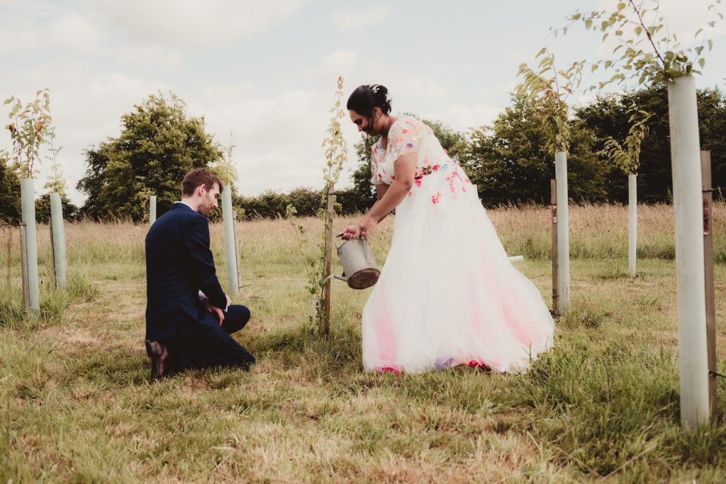 a bride and groom during a tree planting ceremony at the matara centre