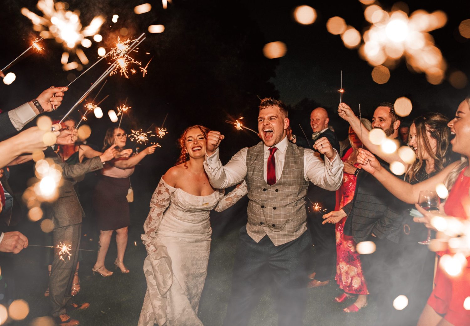 Bride and grrom during a sparkelr exit at Stanbrook Abbey hotel